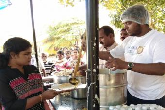 Affected people queue up to receive food