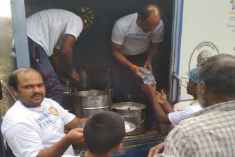 Packaged drinking water being handed out