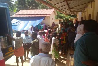 Akshaya Patra volunteers ensuring the food is served in an orderly manner