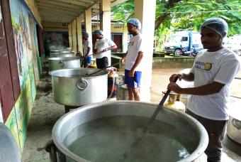 Rice being cooked in huge cauldrons