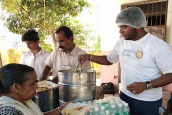 Flood-affected people being served with fresh food