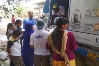 People assemble at the food distribution area