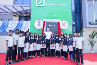 Mr Benjamin Alka, Managing Director of Deutsche Bank, with children benefitting from the new kitchen