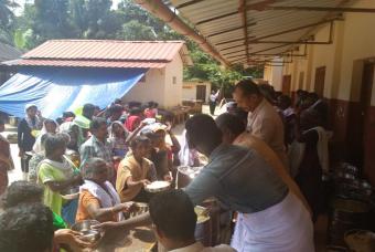 Flood affected people enjoying the food