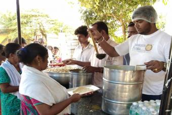People in Edathua being served with chapati, curry, and pulao