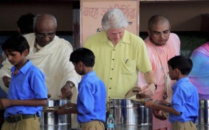 Clinton serves mid-day meals to the children. Photo credit: Clinton Foundation/ Barbara Kinney