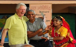 Clinton is delighted to watch a cultural programme arranged at the school. Photo credit: Clinton Foundation/ Barbara Kinney