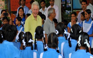 Clinton shares a light moment with the children. Photo credit: Clinton Foundation/ Barbara Kinney