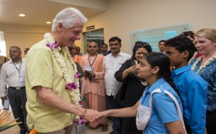 Clinton interacts with some of the school children. Photo credit: Clinton Foundation/ Barbara Kinney